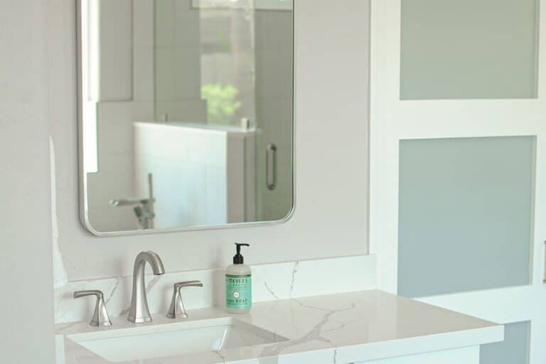 A bathroom counter, sink, and mirror