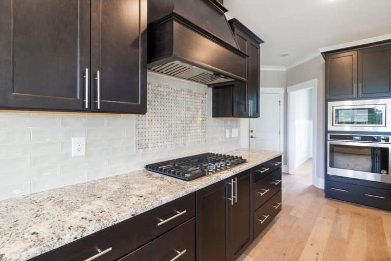 Stone countertops and dark brown wood cabinets