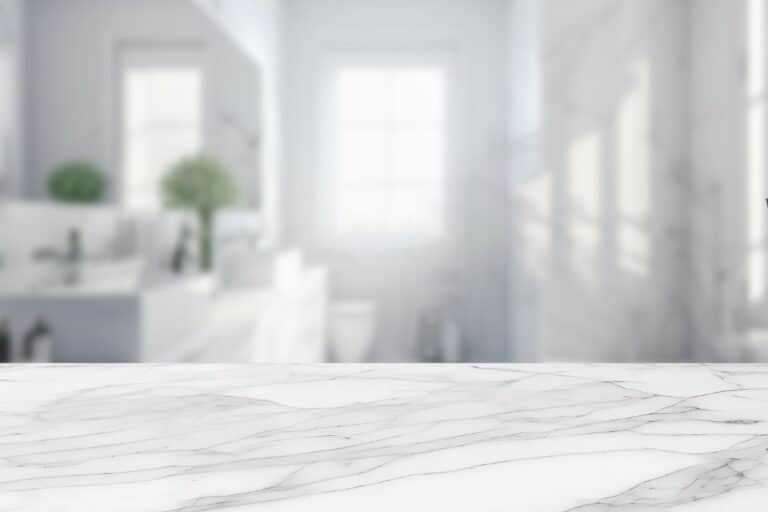 Closeup of a marble countertop. The living space in the background is artistically blurred